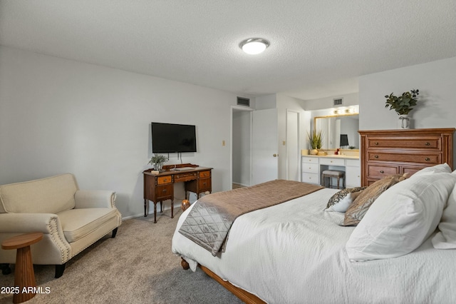 bedroom with light carpet, a textured ceiling, visible vents, and baseboards