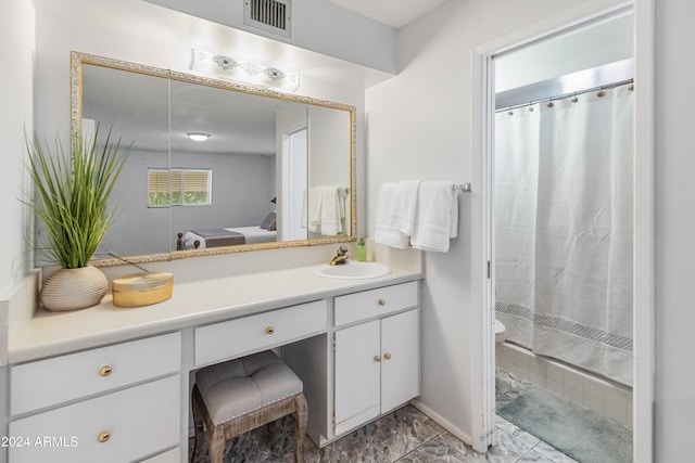 ensuite bathroom with visible vents, ensuite bathroom, curtained shower, marble finish floor, and vanity