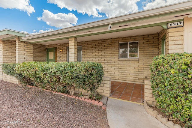 entrance to property with brick siding