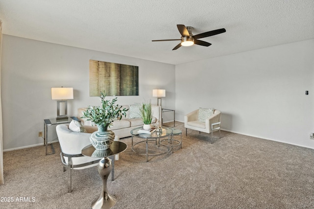 carpeted living area featuring ceiling fan, baseboards, and a textured ceiling