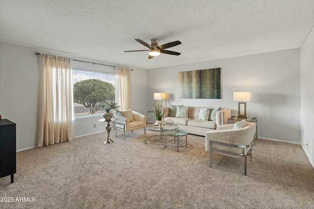 carpeted living area with a textured ceiling, a ceiling fan, and baseboards