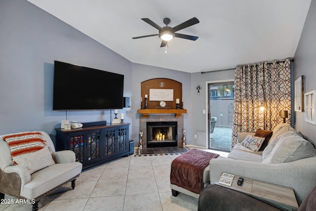 tiled living room with a fireplace and ceiling fan