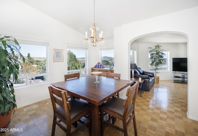 11430 E Manzanita Trl, Dewey, AZ 86327 - dining room with arched walkways, lofted ceiling, a chandelier, and baseboards