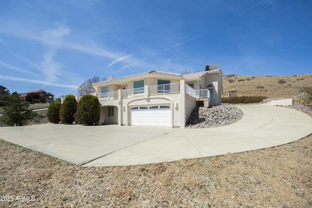 11430 E Manzanita Trl, Dewey, AZ 86327 - view of side of home featuring a balcony, driveway, a garage, and stucco siding