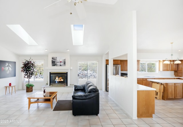 11430 E Manzanita Trl, Dewey, AZ 86327 - living area featuring lofted ceiling, plenty of natural light, a skylight, a glass covered fireplace, and ceiling fan
