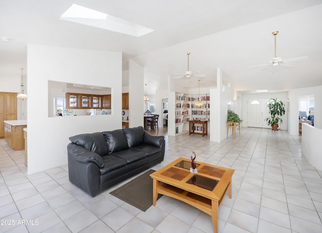11430 E Manzanita Trl, Dewey, AZ 86327 - living room with ceiling fan, vaulted ceiling, a skylight, and light tile patterned flooring