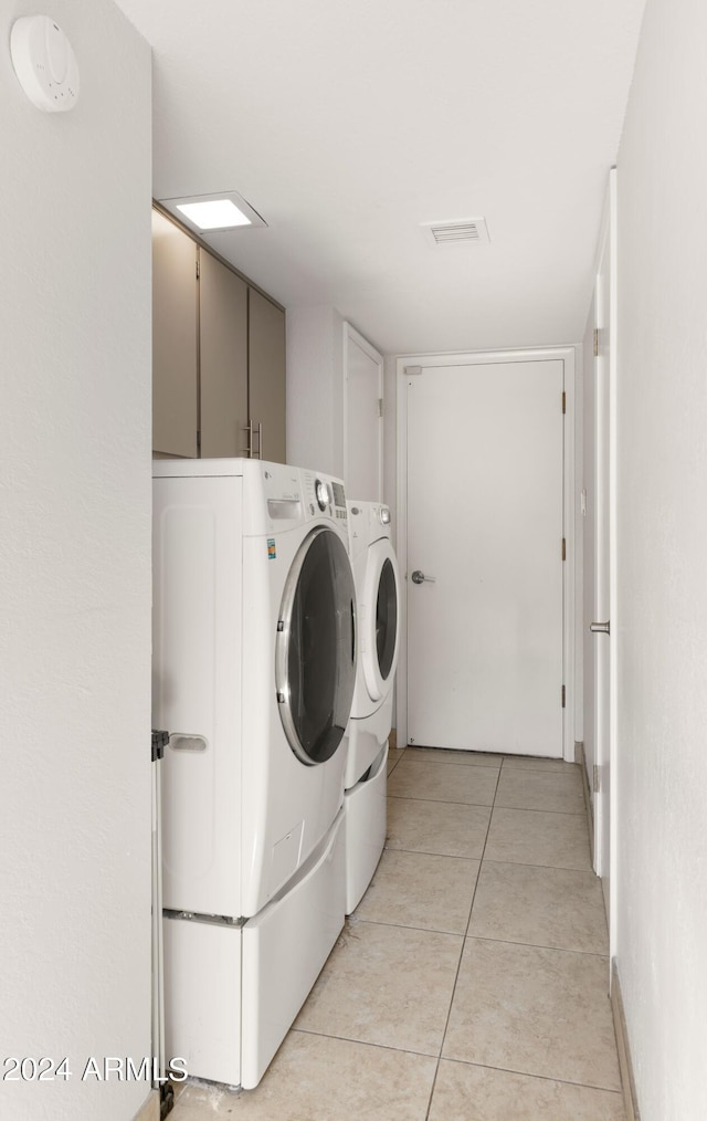 7012 N 22nd St, Phoenix, AZ 85020 - laundry area featuring washer and dryer, cabinets, and light tile patterned floors