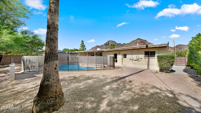7012 N 22nd St, Phoenix, AZ 85020 - back of house with a mountain view, a patio, and a fenced in pool