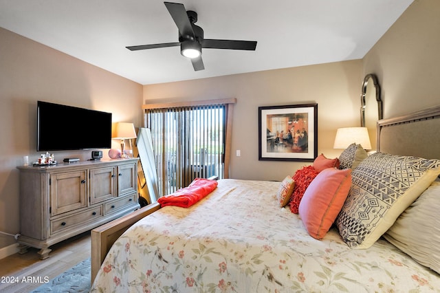 bedroom featuring access to exterior, hardwood / wood-style flooring, and ceiling fan