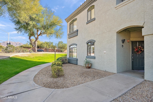 view of property exterior with a yard