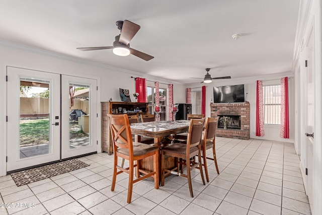 1723 W Mercury Way, Chandler, AZ 85224 - dining area featuring french doors, ceiling fan, light tile patterned floors, crown molding, and a fireplace