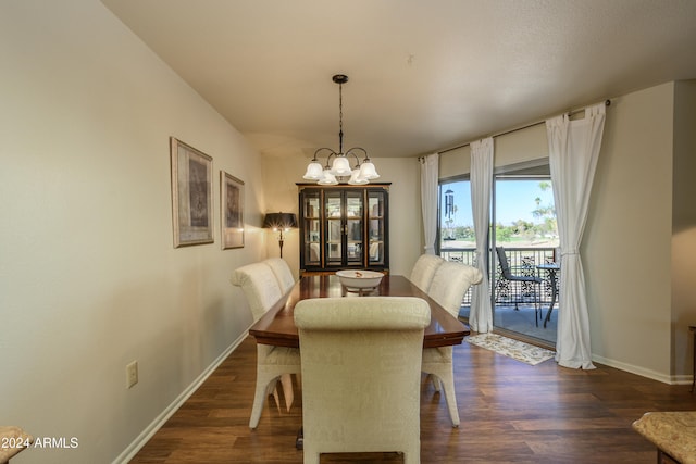 dining space featuring a chandelier and dark hardwood / wood-style flooring