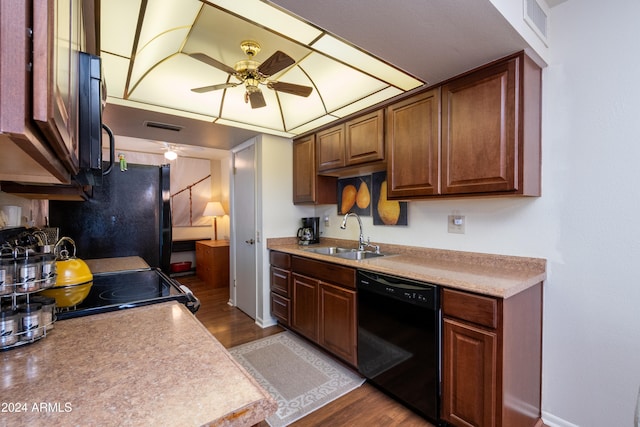 kitchen featuring sink, light hardwood / wood-style flooring, ceiling fan, and black appliances