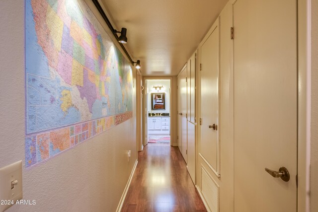 hall with hardwood / wood-style floors