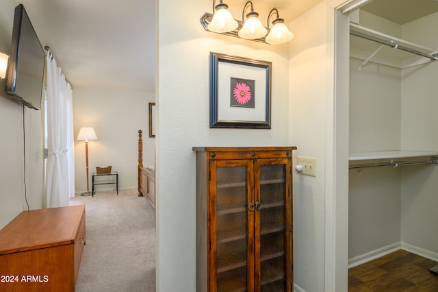 spacious closet featuring a chandelier and hardwood / wood-style flooring