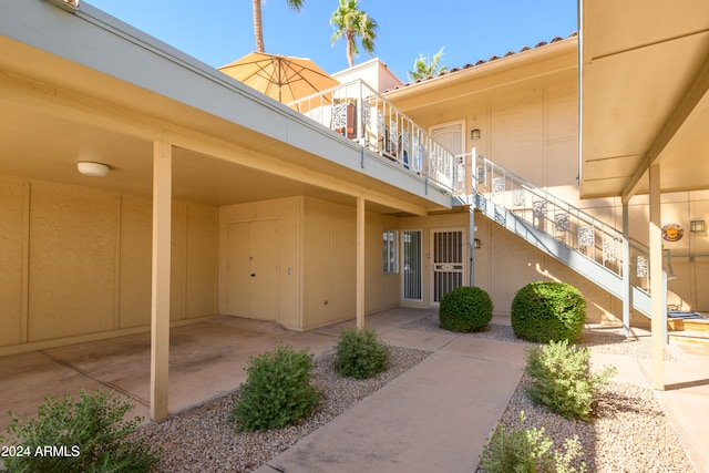 view of exterior entry with a patio