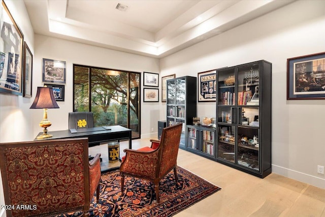 home office featuring a raised ceiling