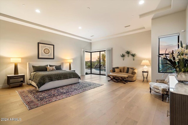 bedroom with light wood-type flooring and access to exterior