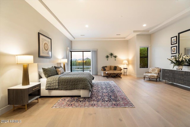 bedroom featuring light hardwood / wood-style floors and access to exterior