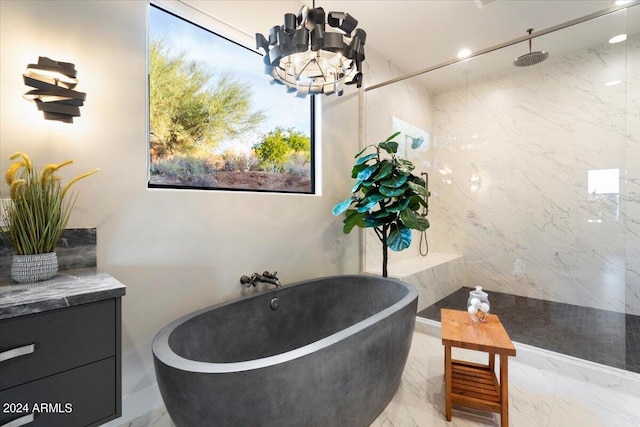 bathroom with plus walk in shower, a chandelier, vanity, and tile walls