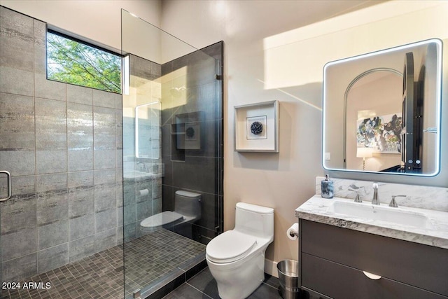 bathroom featuring tile patterned floors, vanity, a shower with door, and toilet