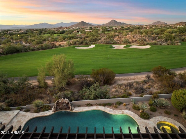 exterior space featuring a yard, a mountain view, and a swimming pool