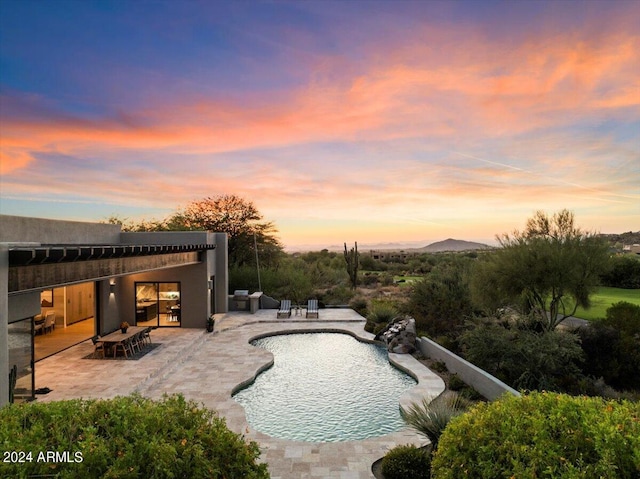 pool at dusk with a patio