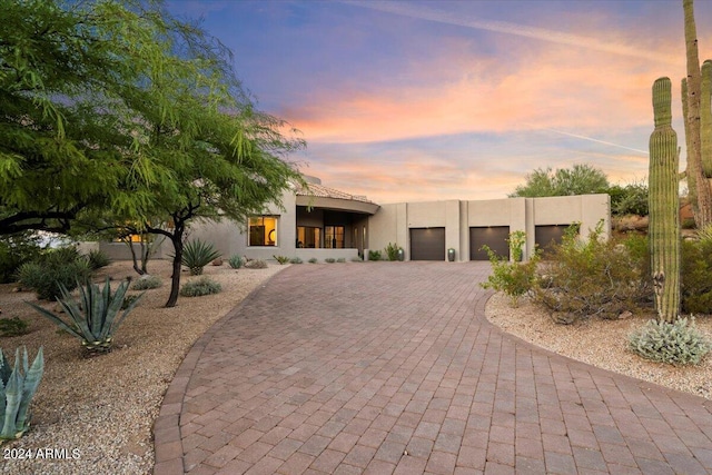 pueblo-style house with a garage