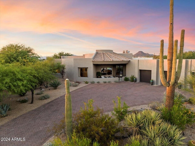 southwest-style home featuring a garage