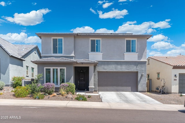 21134 W Minnezona Ave, Buckeye, AZ 85396 - view of front of home with an attached garage, driveway, and stucco siding
