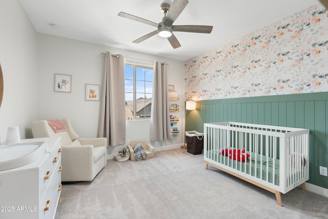 21134 W Minnezona Ave, Buckeye, AZ 85396 - carpeted bedroom with a nursery area, a wainscoted wall, ceiling fan, wallpapered walls, and baseboards