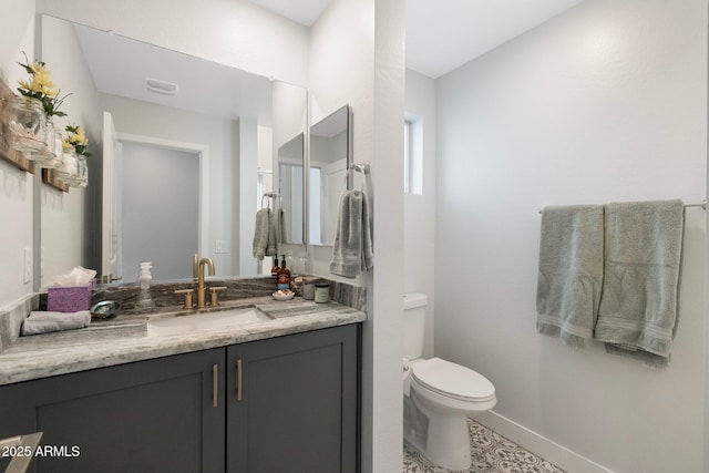 21134 W Minnezona Ave, Buckeye, AZ 85396 - bathroom featuring toilet, vanity, and baseboards