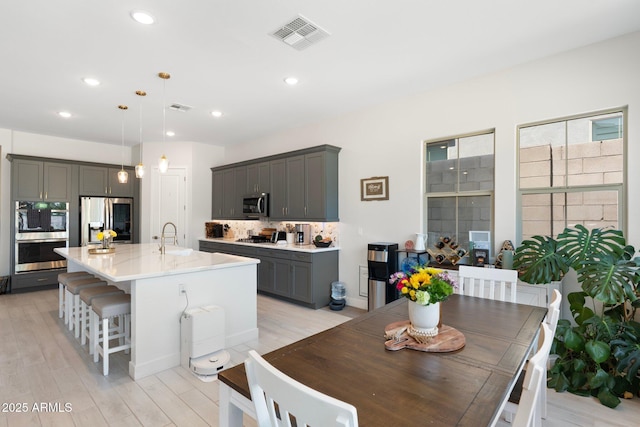 21134 W Minnezona Ave, Buckeye, AZ 85396 - dining space with light wood-type flooring and recessed lighting