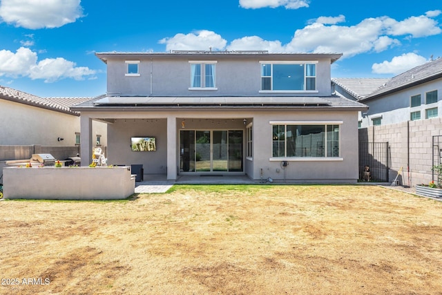 21134 W Minnezona Ave, Buckeye, AZ 85396 - rear view of house with stucco siding and a patio