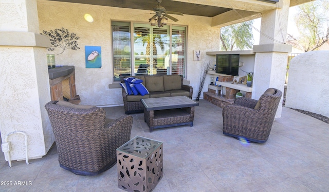 view of patio / terrace featuring ceiling fan and an outdoor living space