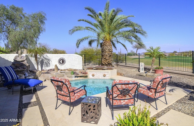 view of swimming pool with a patio area, fence, and a fenced in pool