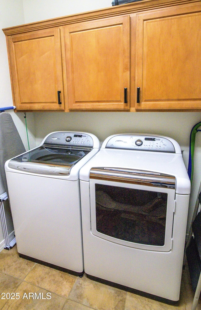 laundry area featuring cabinet space and separate washer and dryer