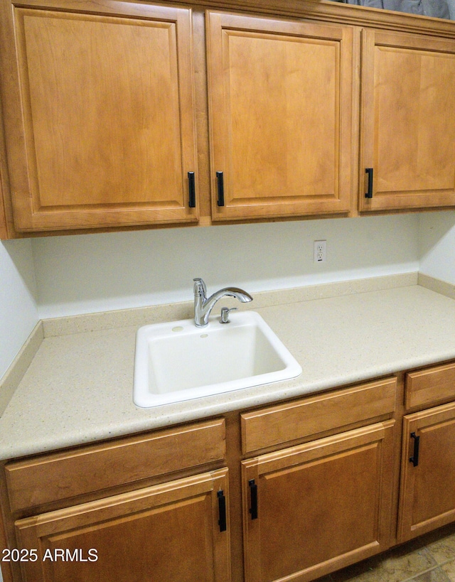 interior space featuring light countertops, brown cabinetry, and a sink