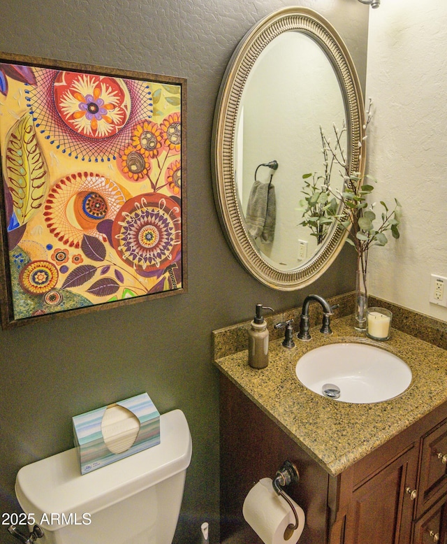 bathroom featuring toilet and vanity