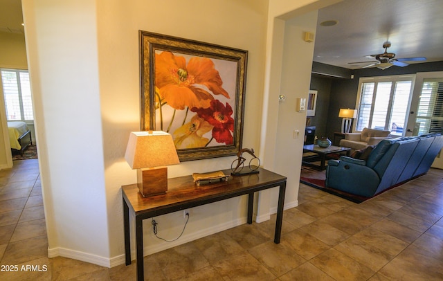 hall featuring a wealth of natural light and baseboards