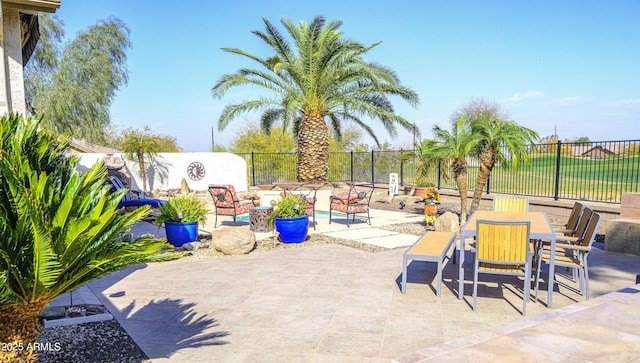 view of patio with outdoor dining area and fence