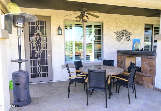 view of patio featuring a ceiling fan and outdoor dining area