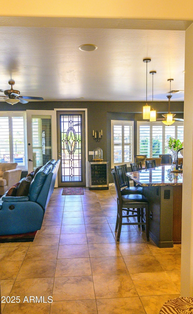 dining area with a ceiling fan and tile patterned floors