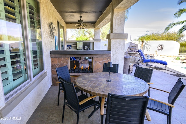 view of patio with a ceiling fan and outdoor dining area