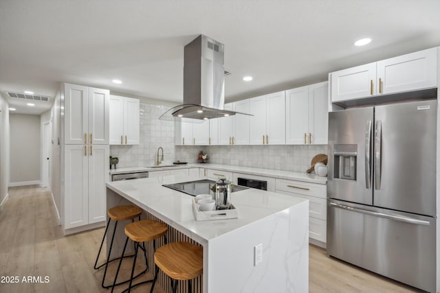 kitchen with white cabinetry, island exhaust hood, light stone counters, a kitchen island, and stainless steel fridge with ice dispenser