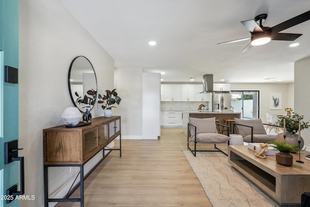 living room featuring light hardwood / wood-style flooring and ceiling fan