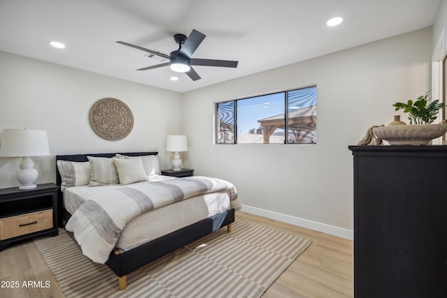 bedroom with ceiling fan and light hardwood / wood-style flooring