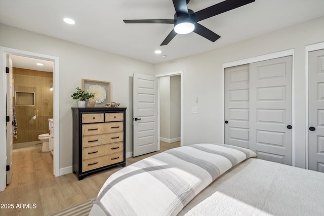 bedroom featuring ensuite bathroom, ceiling fan, and light hardwood / wood-style flooring