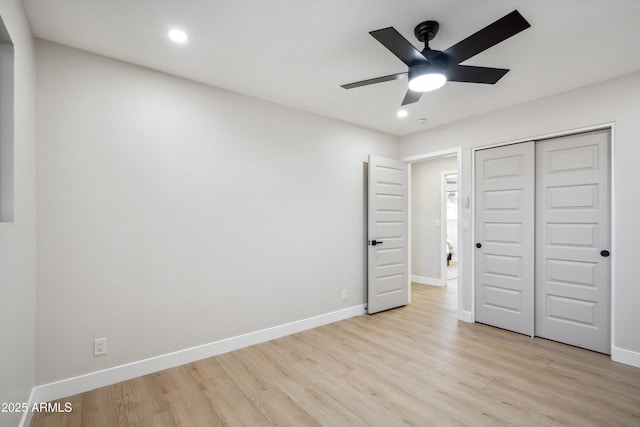 unfurnished bedroom featuring light hardwood / wood-style flooring, a closet, and ceiling fan