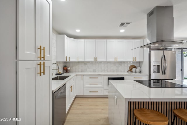 kitchen with white cabinetry, sink, island range hood, and stainless steel appliances